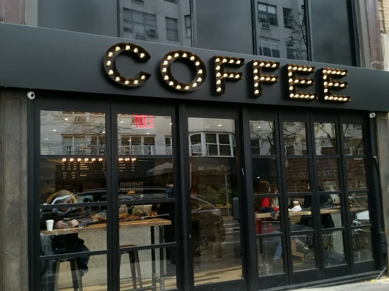 metal signage and black business awnings olympic pita